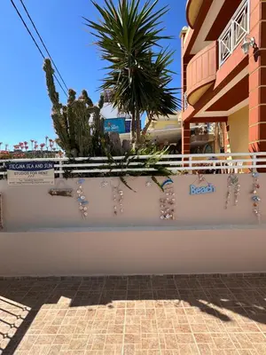 a white fence with pearl earrings and plants on it at Stegna Sea & Sun in Archangelos