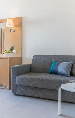 a living room with a couch and a table at City Center Hotel in Rhodes Town