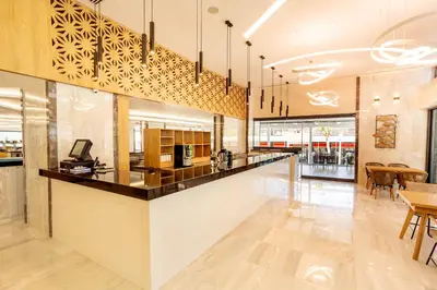 a lobby with a counter and a dining area at Rhodos Horizon City-Adults Only in Rhodes Town