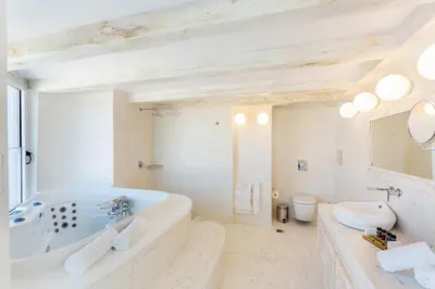 a white bathroom with a tub and a sink at Rhodos Horizon City-Adults Only in Rhodes Town