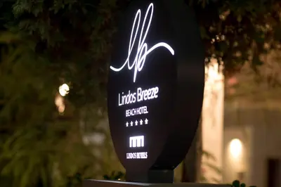 a sign for a music bar with a light on it at Lindos Breeze Beach Hotel in Kiotari