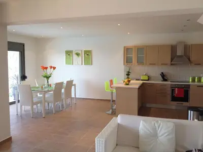 a living room and kitchen with a table and chairs at Villa Anna in Pefki Rhodes