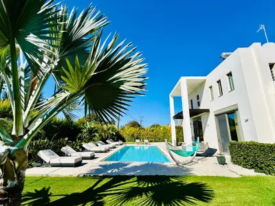 a villa with a swimming pool and a house at Filerimos Oasis Luxury Villa in Ialyssos