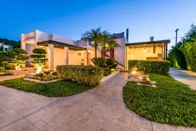 an exterior view of a house with a garden at Filerimos Oasis Luxury Villa in Ialyssos