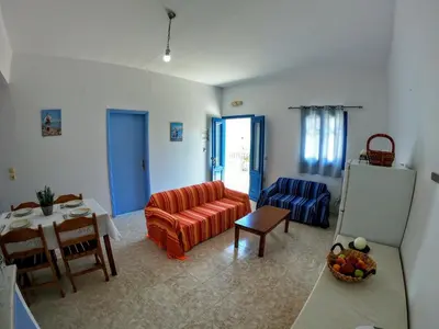 a living room with a couch and a table at Irene Family Apartment in Symi