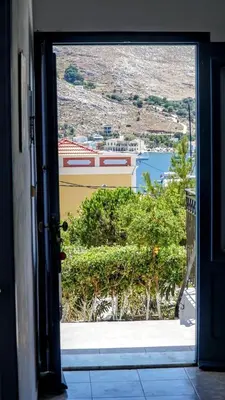 an open door with a view of a city at Irene Family Apartment in Symi