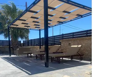 a pavilion with chairs and a picnic table under it at Costa Gennadi Villa in Gennadi