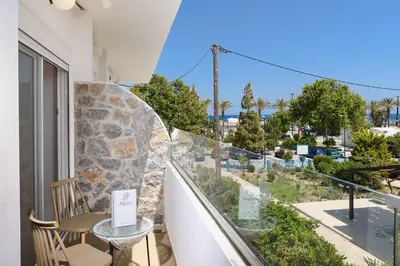 a balcony with a table and a view of a street at Mylos Luxury Escape in Faliraki