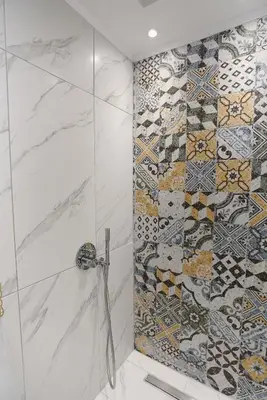 a bathroom with a shower with mosaic tiles on the wall at Mylos Luxury Escape in Faliraki