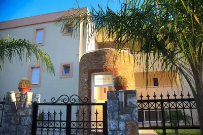 a black fence in front of a building at Lindos Blue Sky in Líndos