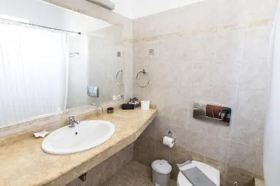 a bathroom with a sink and a toilet at Lindos Blue Sky in Líndos