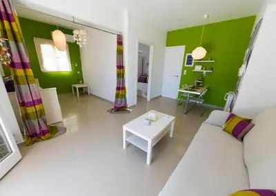 a living room with a couch and a table at Uno Beachfront Suite in Livadia