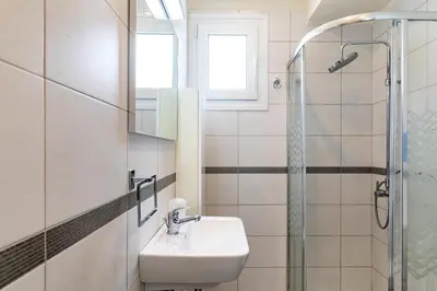 a bathroom with a sink and a shower at ELENA HOUSE 2 in Gennadi