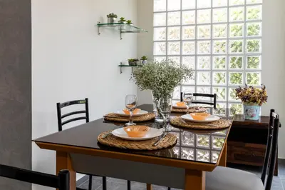 a dining room with a table and chairs and a window at ELENA HOUSE 2 in Gennadi