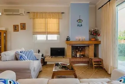 a living room with a couch and a fireplace at Gennadi Villa Del Mar in Gennadi