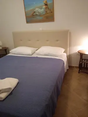 a bedroom with two beds and a painting on the wall at Gennadi Villa Del Mar in Gennadi