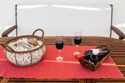 a table with two glasses of wine and a basket of food at Gennadi Villa Del Mar in Gennadi