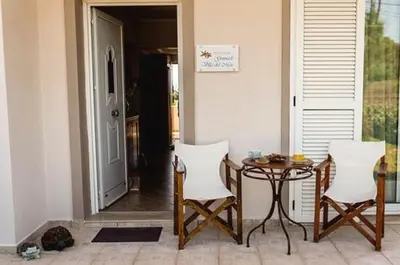 a room with a table and two chairs and a table at Gennadi Villa Del Mar in Gennadi