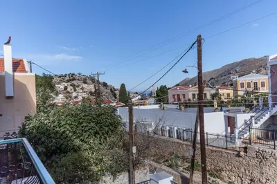 a view from the balcony of a town with houses at Casa Rinio in Symi