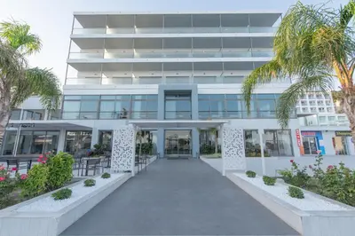 a building with a walkway in front of it at Belair Beach Hotel in Ixia