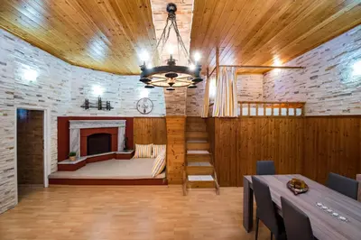 a large room with a bed and a fireplace at Sioutis House in Soroni