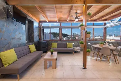 a patio with couches and a table and chairs at Sioutis House in Soroni