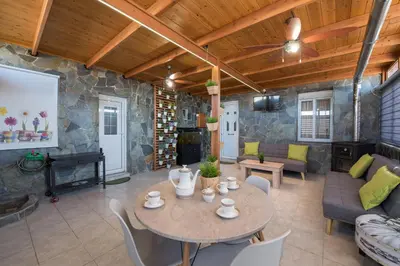 a living room with a table and a fireplace at Sioutis House in Soroni