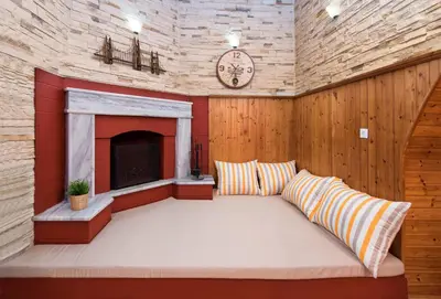 a living room with a couch and a fireplace at Sioutis House in Soroni