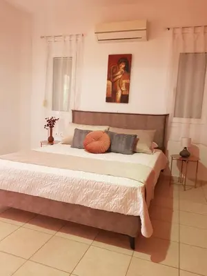 a bedroom with a large bed in a room at Theti Apartment in Faliraki