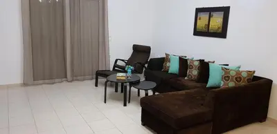 a living room with a couch and a table at Theti Apartment in Faliraki
