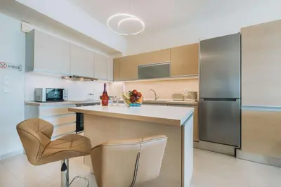 a kitchen with a counter and a refrigerator at Rhodes Port Haven Suite in Rhodes Town