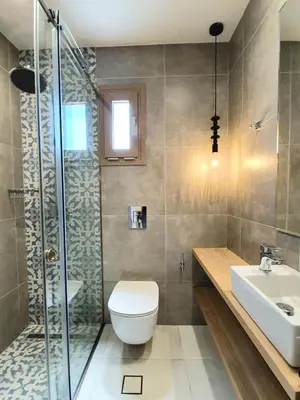 a bathroom with a toilet and a shower and a sink at St.Thomas Beach Luxury Apartments in Pefki Rhodes