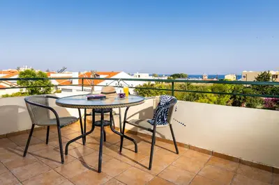 a table and chairs on a balcony with a view at Villas Duc - Rhodes in Ialyssos