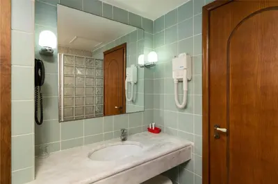 a bathroom with a sink and a mirror at Villas Duc - Rhodes in Ialyssos