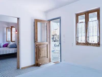 a room with a door and a room with a couch at KALITHEA-HILLS APARTMENT 3 in Koskinou