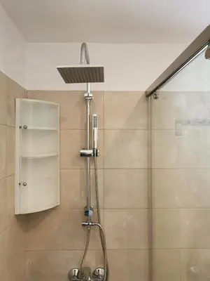 a shower with a shower head in a bathroom at RUSTIC SELF-INN in Rhodes Town