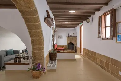 a living room with an archway and a fireplace at RUSTIC SELF-INN in Rhodes Town
