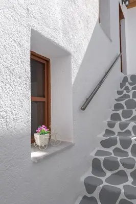 a window with a flower pot on a window sill at RUSTIC SELF-INN in Rhodes Town