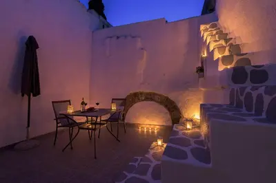 a dining room with a table and chairs and lights at RUSTIC SELF-INN in Rhodes Town