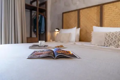 a book sitting on top of a bed with a tray at Oasis Hotel Prasonisi in Prasonisi