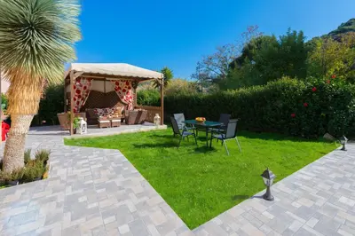a patio with a table and a gazebo at EvMar Villa in Rhodes Town