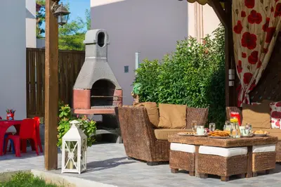 a patio with a table and a pizza oven at EvMar Villa in Rhodes Town