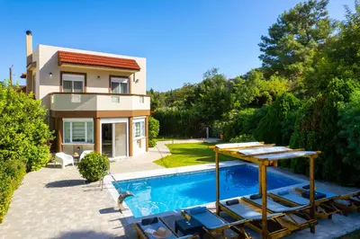 a villa with a swimming pool and a house at EvMar Villa in Rhodes Town