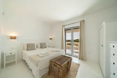 a white bedroom with a bed and a balcony at KALITHEA-HILLS VILLA with pool for 8 up to 12 IN RHODES TOWN in Rhodes Town