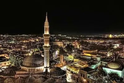 a view of a city at night with a tall tower at KALITHEA-HILLS VILLA with pool for 8 up to 12 IN RHODES TOWN in Rhodes Town
