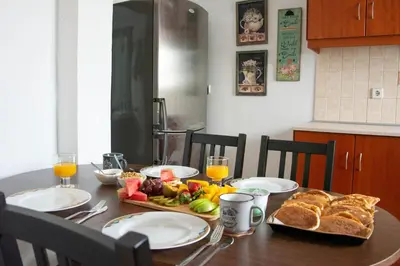 a table with bread and fruit on it with glasses of orange juice at Anesis Traditional Rhodian House in Kattavía