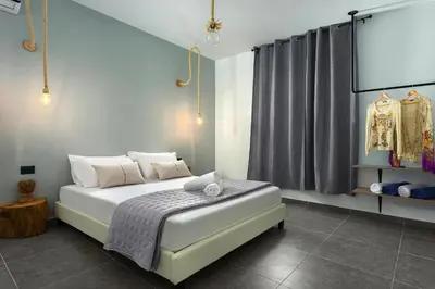 a bedroom with a bed and a window with a curtain at Luxury villa in Lachania near sea in Lachania