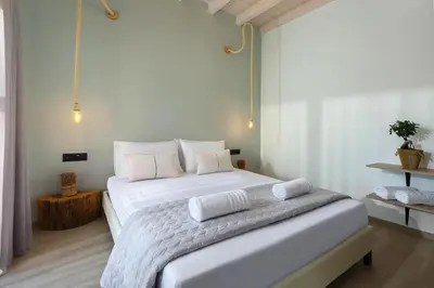 a bedroom with a large white bed with two pillows at Luxury villa in Lachania near sea in Lachania