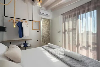 a bedroom with a large white bed and a window at Luxury villa in Lachania near sea in Lachania