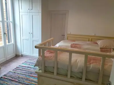 a bedroom with a bed with a wooden frame at Alexandros Traditional House in Ialyssos